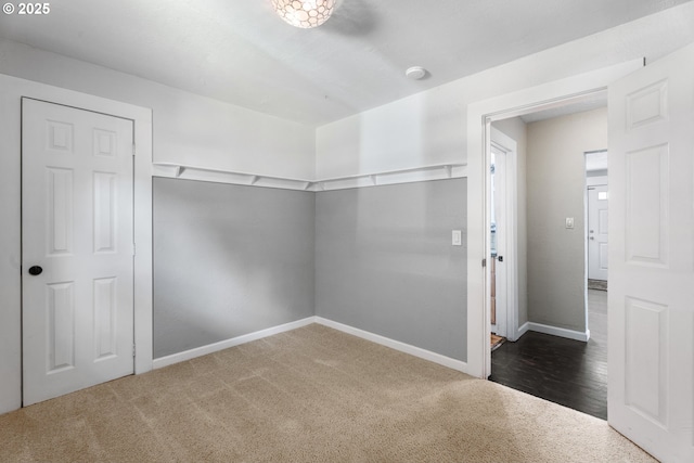 interior space featuring carpet floors and baseboards