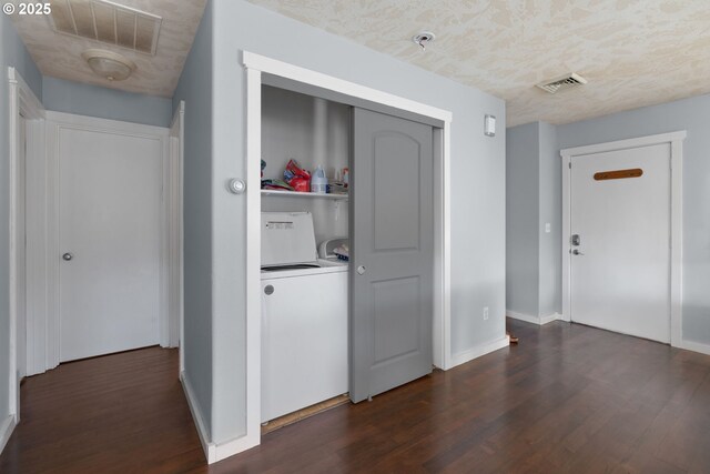 hallway featuring dark wood-type flooring and washer / dryer