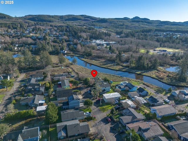 drone / aerial view featuring a water and mountain view