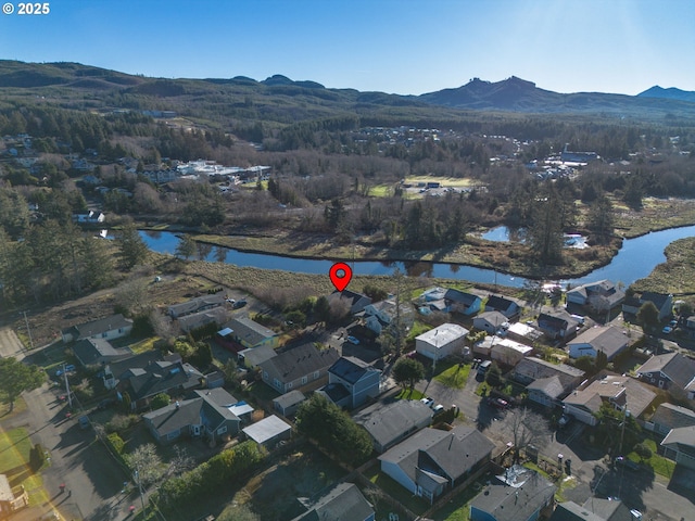 birds eye view of property featuring a water and mountain view