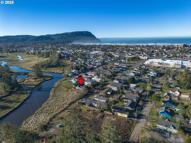 drone / aerial view featuring a water and mountain view