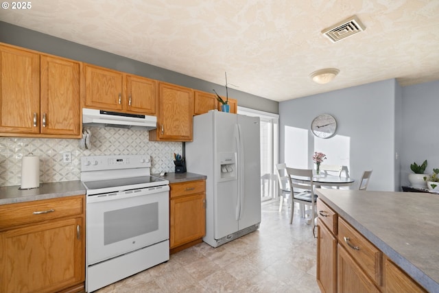 kitchen with white appliances and decorative backsplash