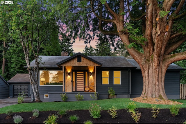 7170 SW 76th Ave, Portland, OR 97223 - ranch-style home with a chimney, a yard, a shingled roof, and a detached garage