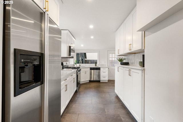 7170 SW 76th Ave, Portland, OR 97223 - kitchen with stainless steel appliances, recessed lighting, light countertops, tasteful backsplash, and white cabinets
