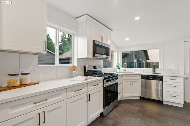 7170 SW 76th Ave, Portland, OR 97223 - kitchen with stainless steel appliances, tasteful backsplash, white cabinetry, recessed lighting, and light stone counters
