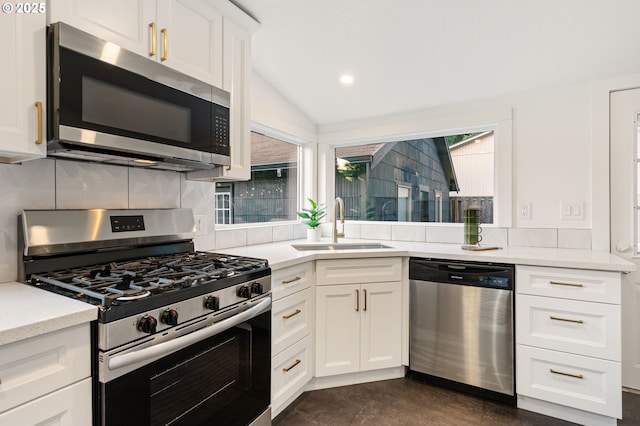 7170 SW 76th Ave, Portland, OR 97223 - kitchen featuring appliances with stainless steel finishes, tasteful backsplash, white cabinets, vaulted ceiling, and recessed lighting