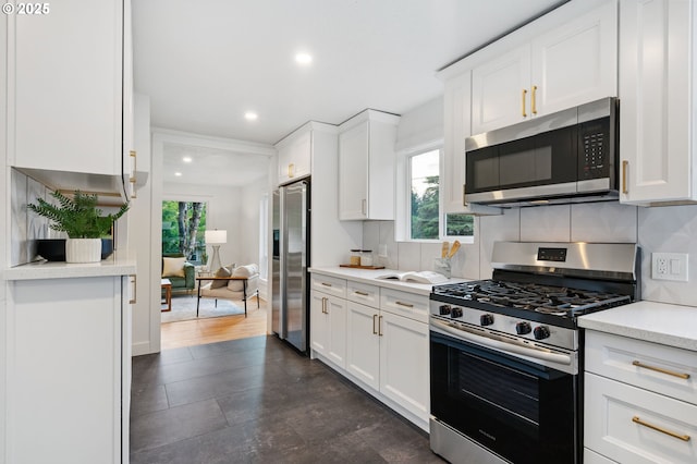 7170 SW 76th Ave, Portland, OR 97223 - kitchen featuring stainless steel appliances, healthy amount of natural light, recessed lighting, light countertops, and white cabinetry