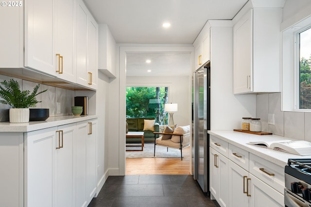 7170 SW 76th Ave, Portland, OR 97223 - kitchen featuring appliances with stainless steel finishes, light countertops, white cabinets, decorative backsplash, and recessed lighting