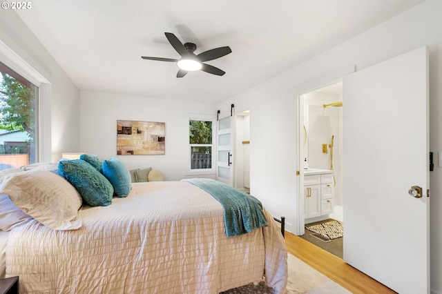 7170 SW 76th Ave, Portland, OR 97223 - bedroom with light wood-style flooring, ensuite bathroom, and a ceiling fan