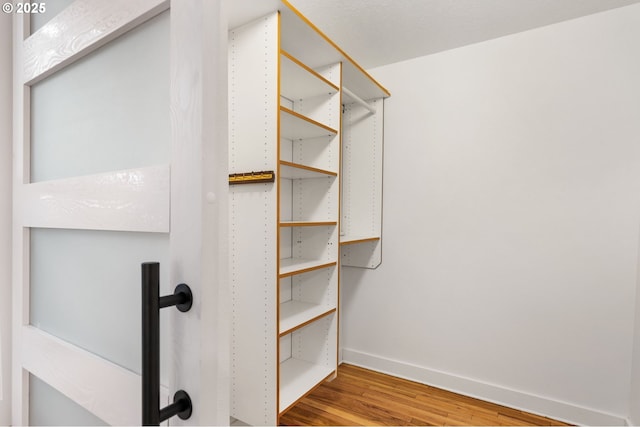 7170 SW 76th Ave, Portland, OR 97223 - walk in closet featuring wood finished floors