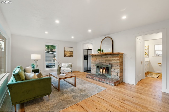 7170 SW 76th Ave, Portland, OR 97223 - living room featuring plenty of natural light, a stone fireplace, light wood finished floors, and recessed lighting