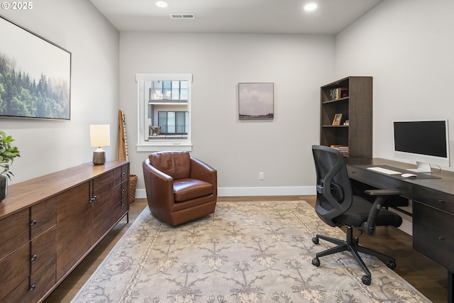 office area featuring light wood-style floors, recessed lighting, visible vents, and baseboards