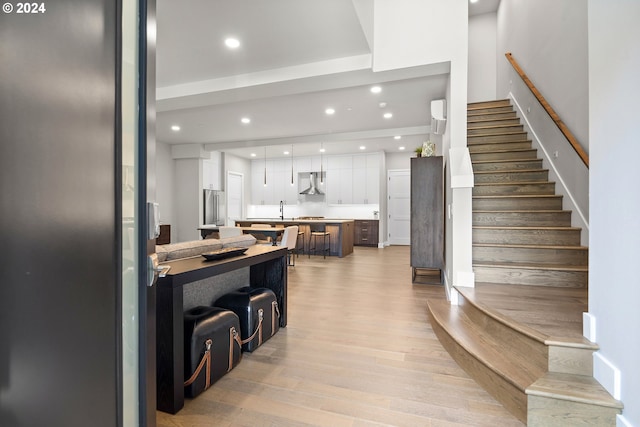 interior space featuring recessed lighting, light wood finished floors, and stairs