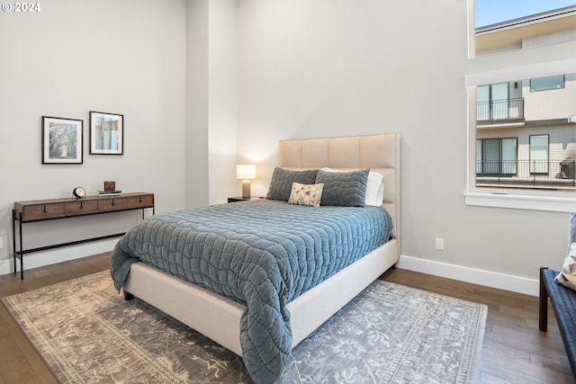 bedroom featuring baseboards and wood finished floors