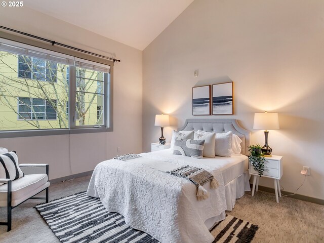 bedroom featuring light carpet and vaulted ceiling