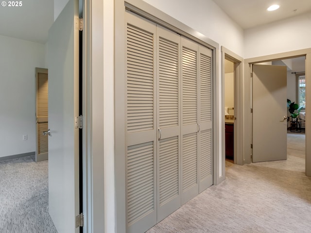 corridor with light colored carpet