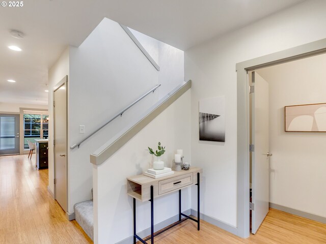 hallway with light hardwood / wood-style floors