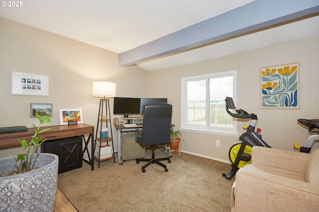 carpeted office with beamed ceiling and baseboards