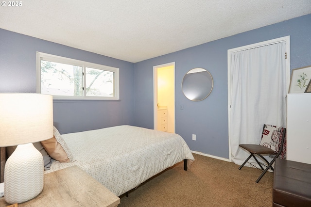 bedroom featuring carpet, baseboards, and a textured ceiling