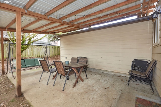 view of patio with outdoor dining space and fence