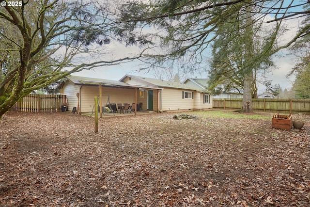 rear view of house featuring a patio area, crawl space, and fence private yard