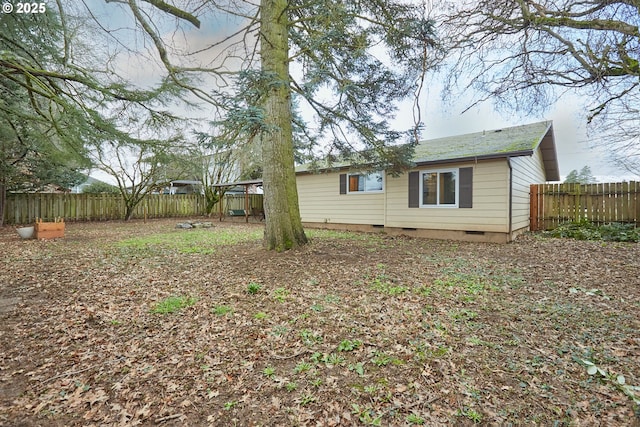 back of house with fence and crawl space