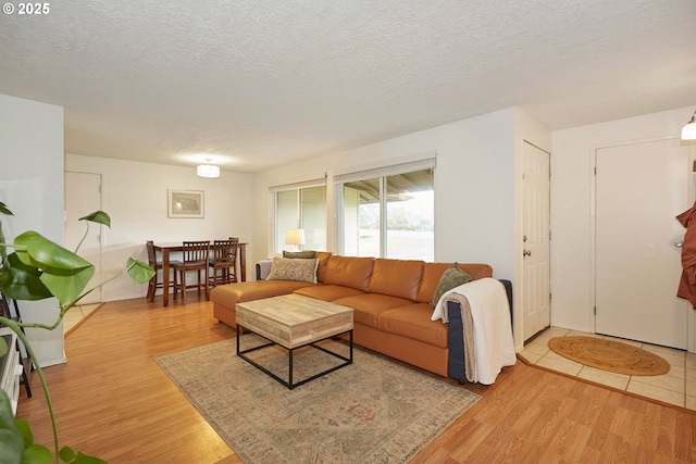 living area with a textured ceiling and wood finished floors