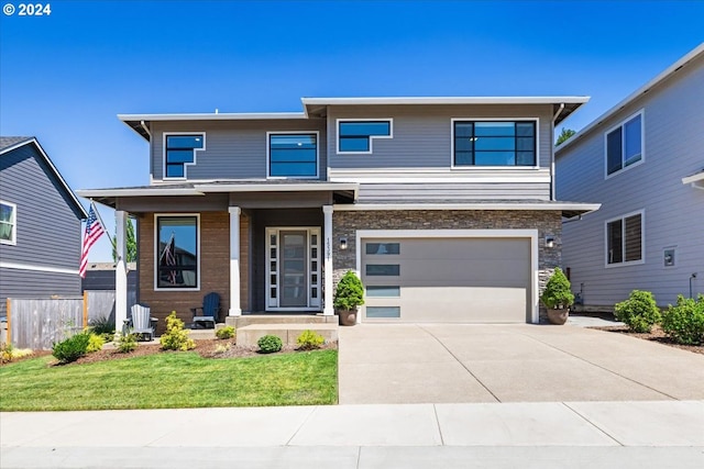 view of front of house featuring a garage and a front lawn