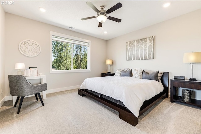 bedroom with light colored carpet and ceiling fan