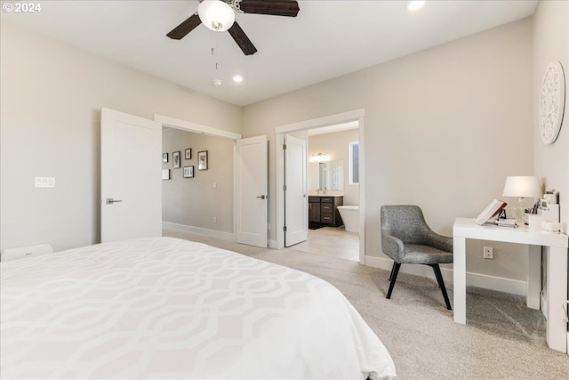 carpeted bedroom featuring ceiling fan and ensuite bathroom