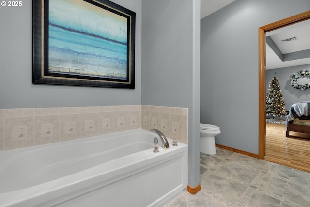 bathroom with a tub and toilet