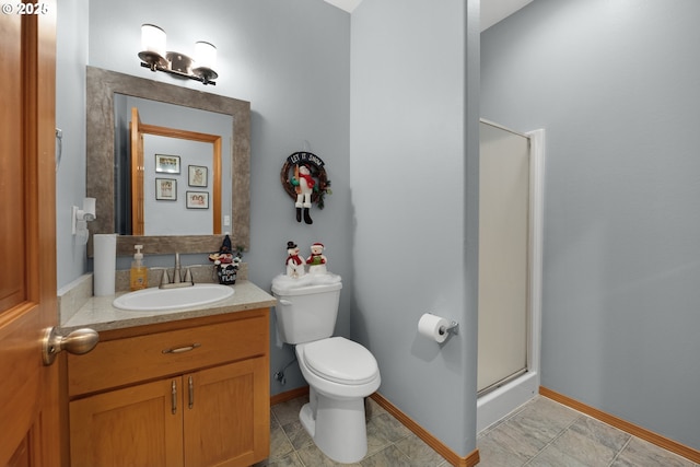 bathroom featuring vanity, toilet, and walk in shower