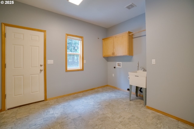 washroom with hookup for a washing machine and cabinets