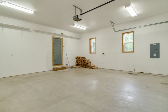 garage with electric panel and a garage door opener