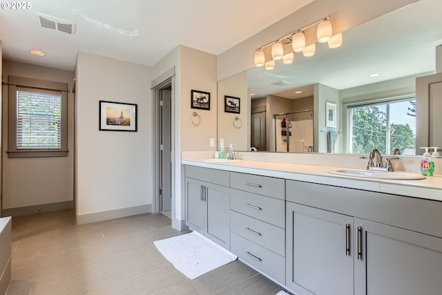 8326 SW Oak St, Portland, OR 97223 - bathroom with double vanity, a stall shower, tile patterned flooring, and recessed lighting