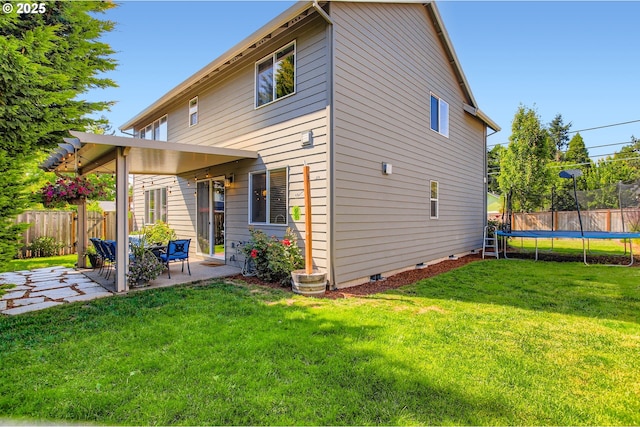 8326 SW Oak St, Portland, OR 97223 - back of property featuring a trampoline, a patio area, and crawl space