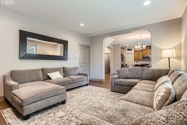 8326 SW Oak St, Portland, OR 97223 - living room with arched walkways, wood finished floors, recessed lighting, and a chandelier