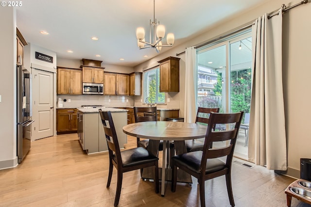8326 SW Oak St, Portland, OR 97223 - dining space featuring a chandelier, light wood-type flooring, and recessed lighting