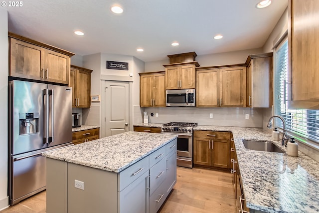 8326 SW Oak St, Portland, OR 97223 - kitchen featuring high quality appliances, healthy amount of natural light, a center island, light stone counters, and recessed lighting