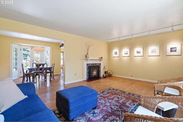 3116 SE 74th Ave, Portland, OR 97206 - living area with rail lighting, wood finished floors, and a tiled fireplace