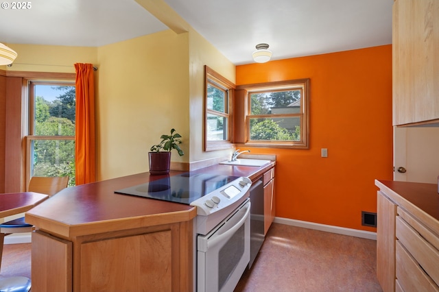 3116 SE 74th Ave, Portland, OR 97206 - kitchen with white electric range oven, dishwasher, light colored carpet, and a peninsula