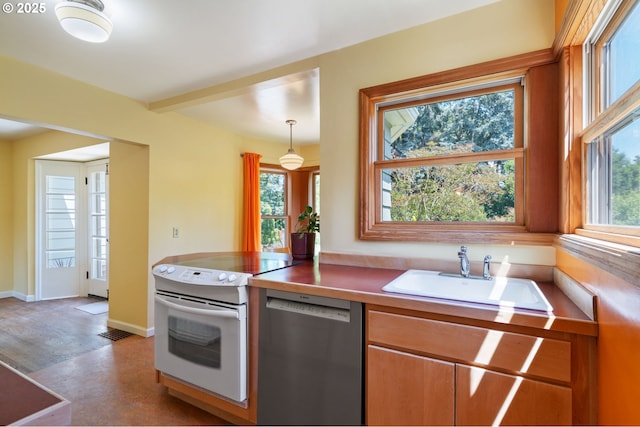 3116 SE 74th Ave, Portland, OR 97206 - kitchen with stainless steel dishwasher, white electric range, and decorative light fixtures