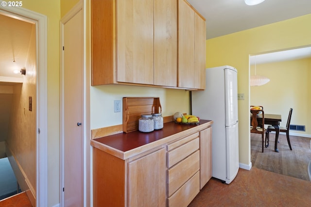 3116 SE 74th Ave, Portland, OR 97206 - kitchen featuring light brown cabinetry, freestanding refrigerator, and dark countertops