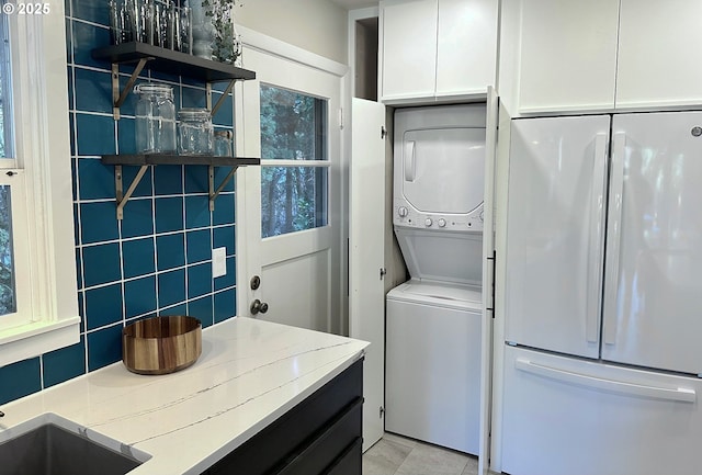 9080 SW Brier Ln, Portland, OR 97223 - laundry room with stacked washer and clothes dryer and light tile patterned floors