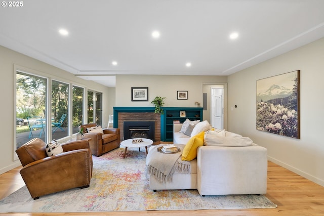 9080 SW Brier Ln, Portland, OR 97223 - living room featuring recessed lighting, a brick fireplace, light wood-style floors, and baseboards