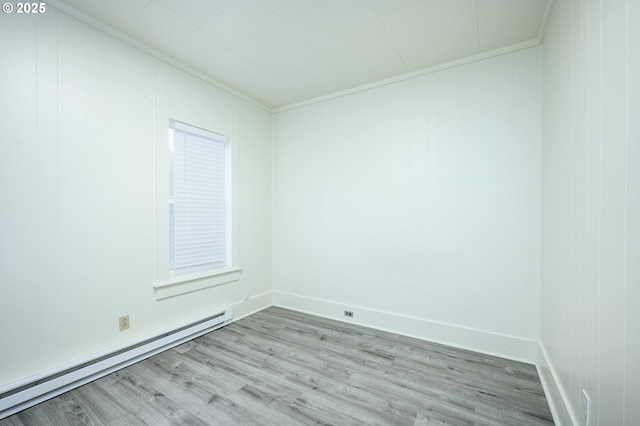 empty room with light wood-type flooring, crown molding, and a baseboard heating unit