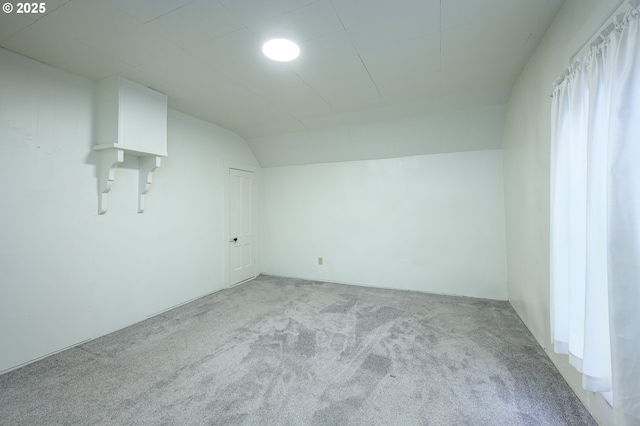 additional living space with light carpet and lofted ceiling