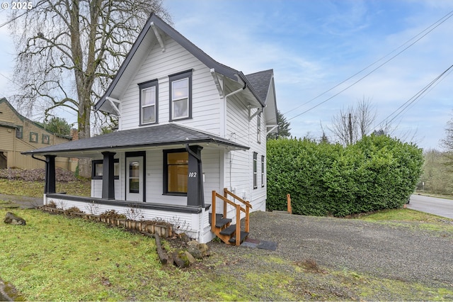 view of front of house with covered porch and a front yard