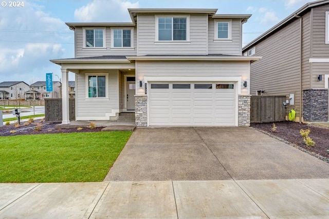 3839 S Arwana Ln, Ridgefield, WA 98642 - view of front of home with a garage, concrete driveway, a front lawn, and stone siding