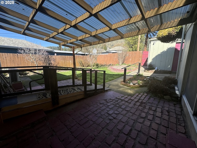 view of patio with a storage shed, an outdoor structure, a fenced backyard, and a pergola